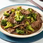 Beef and broccoli recipe served with sauce on a plate