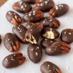 Chocolate-covered pecans dipped in melted dark chocolate for a sweet and salty homemade snack