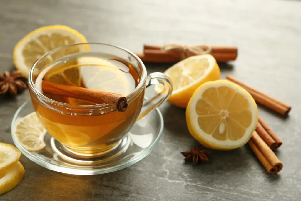 green tea with lemon and cinnamon fat-burning drink in glass cup