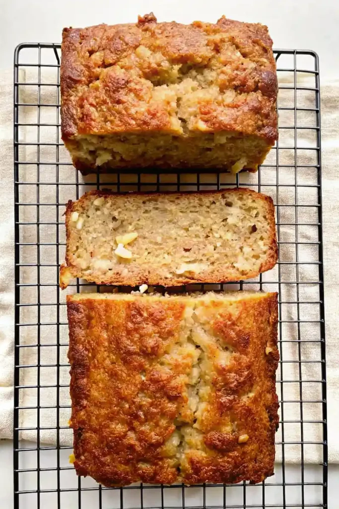 Freshly baked cottage cheese banana bread sliced on a cooling rack