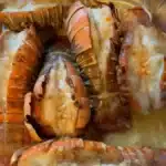 Baked lobster tails with garlic butter cooked in the oven until tender and juicy