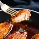Irresistible honey garlic salmon glazed and pan-seared flaky salmon bite lifted with a fork