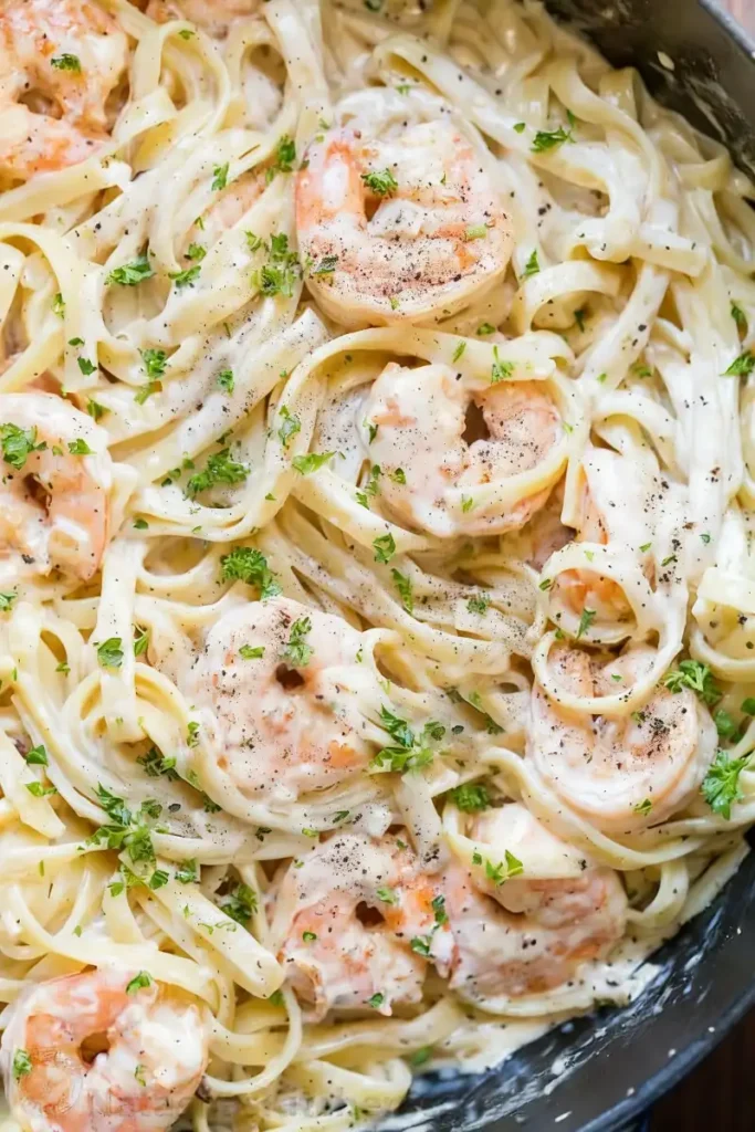 Creamy seafood pasta with shrimp, fettuccine, garlic cream sauce, and fresh parsley