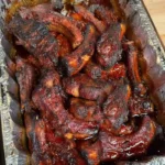 Best BBQ ribs baked until tender with sticky barbecue sauce