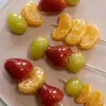 Tanghulu recipe: colorful candied fruit skewers with strawberries, grapes, and mandarines coated in crackly sugar shell.